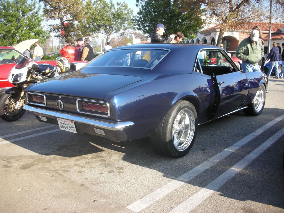 Dark blue first-generation Chevrolet Camaro rear three-quarter at a car meet