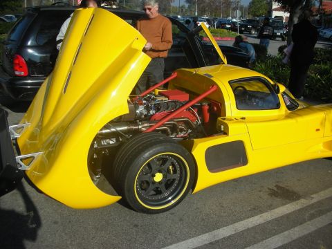 1998 Ford Crown Victoria - Yellow sports car with engine and interior visible, parked outdoors.