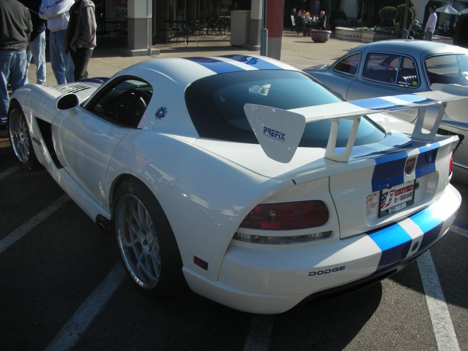 White Dodge Viper coupe with blue stripes and PREFIX wing parked at an outdoor meet