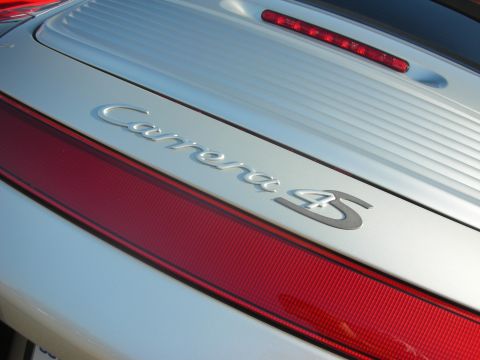 1998 Ford Crown Victoria - The rear emblem of a Porsche Carrera 4S is visible on the silver car.