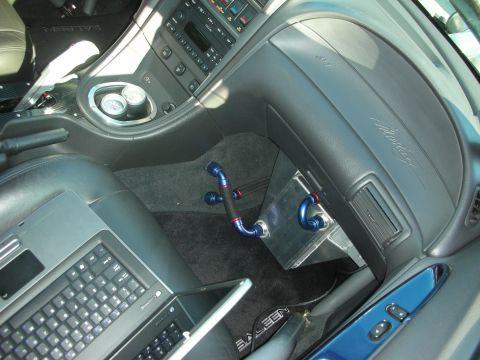 1998 Ford Crown Victoria - The interior of a car shows a laptop and custom plumbing, with "Saleen" branding on the floor mat.