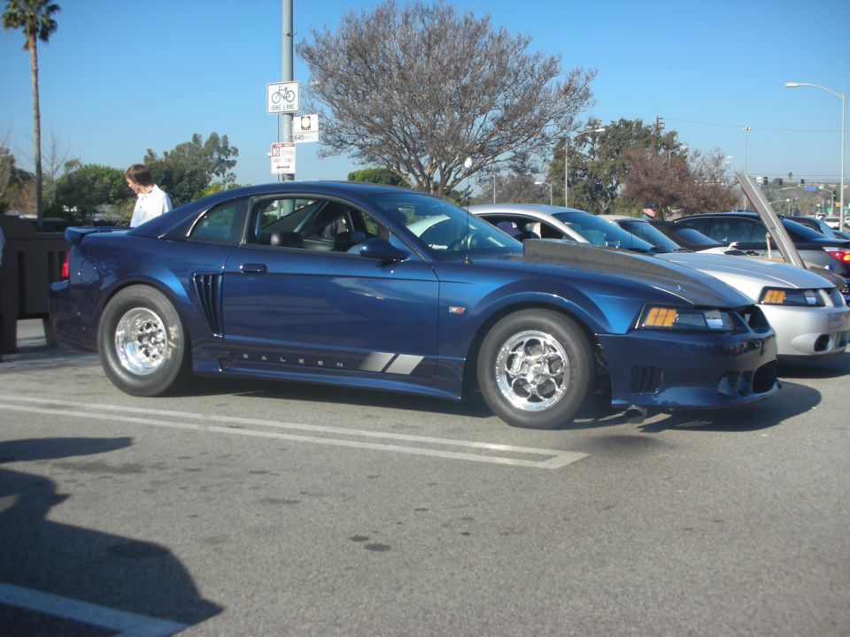 Blue New Edge Ford Mustang with Saleen graphics and drag wheels at a show