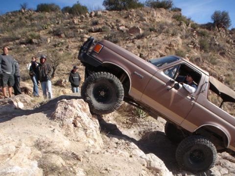 1989 Ford Bronco - 1989 Ford Bronco tackling a challenging off-road trail.