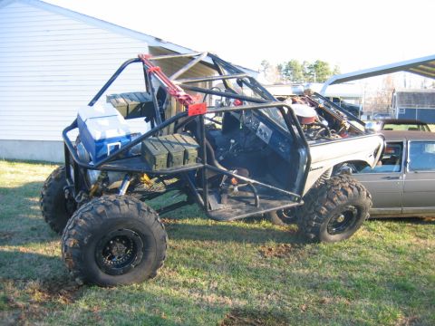 1992 Ford Mustang - Custom off-road buggy with a prominent roll cage and large tires sits on a grassy lawn.