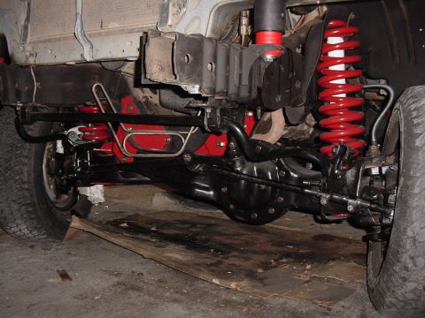 1992 Ford Bronco - Vehicle suspension components, including red coil springs and black differential housing.