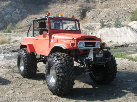 1987 Suzuki Samurai - This heavily modified Toyota Land Cruiser FJ40 sits on a dirt road near a dry creek bed.