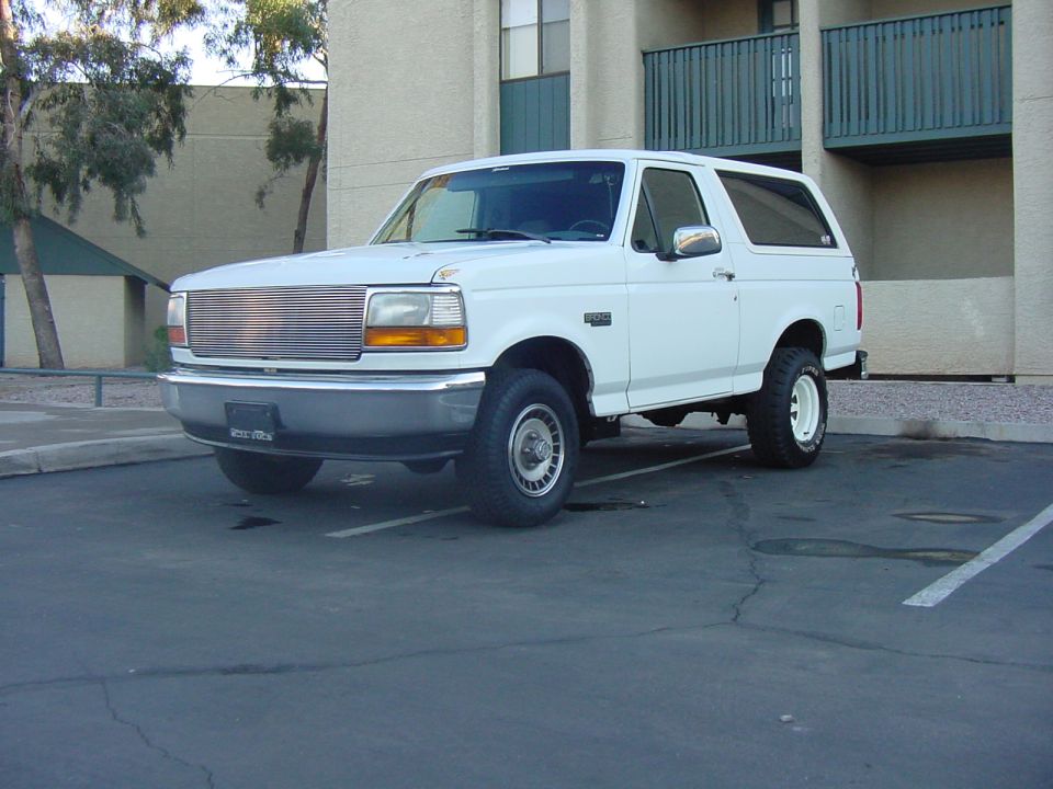 White 1992 Ford Bronco parked in a lot, front 3/4 view