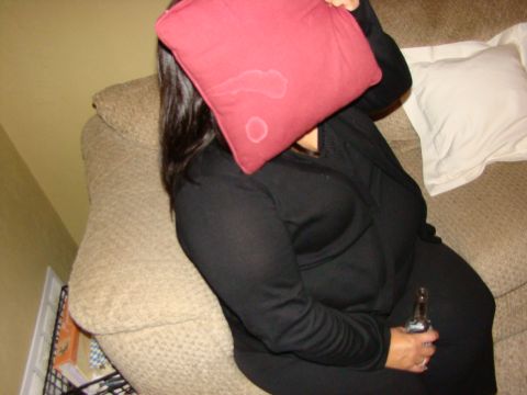 1989 Ford Bronco - A person sits on a couch, obscuring their face with a pillow while holding a bottle.