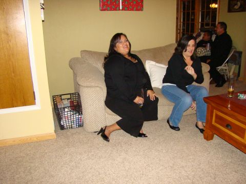 1989 Ford Bronco - People gather in a living room, with two women seated on a couch and others in the background.