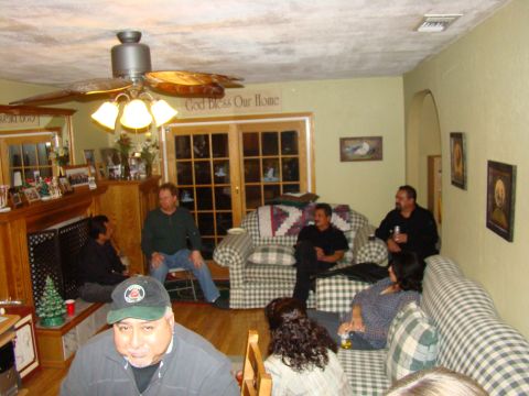 1989 Ford Bronco - A group of people are gathered in a living room, some sitting on couches and chairs.