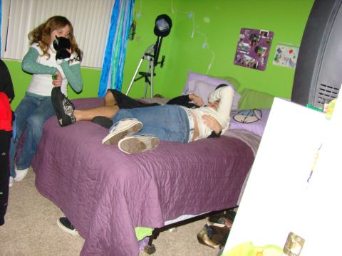 1989 Ford Bronco - A bedroom scene with two teenagers relaxing on a bed, one holding a stuffed toy.