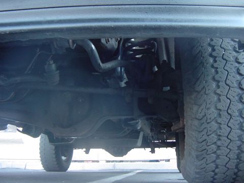 1992 Ford Bronco - Close-up view of the undercarriage, showing suspension parts and the rear differential.