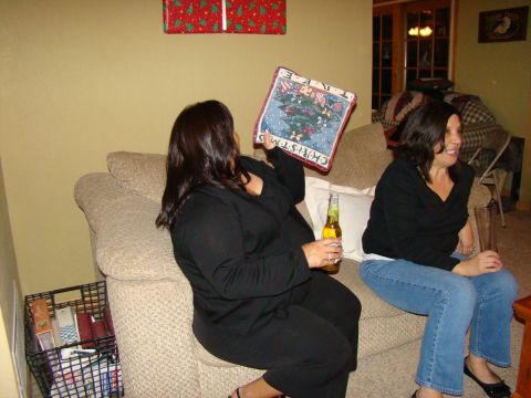 1989 Ford Bronco - Two women relax on a couch, one holding a decorative pillow with a Christmas tree design.