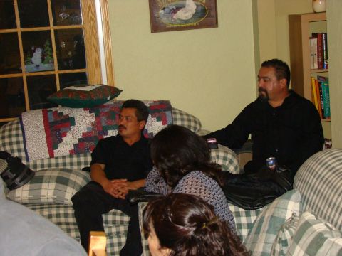 1989 Ford Bronco - Several individuals are seated on couches in a room, with a window visible in the background.