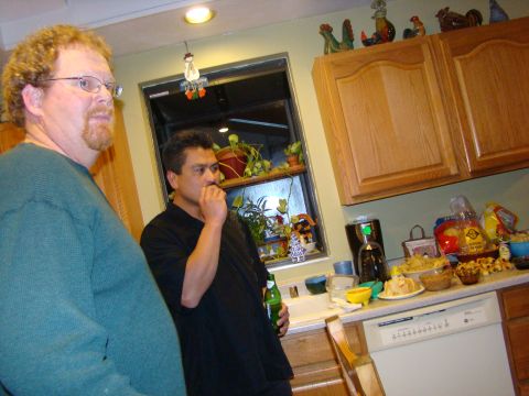 1989 Ford Bronco - Men in a kitchen with snacks on the counter and a dishwasher visible.