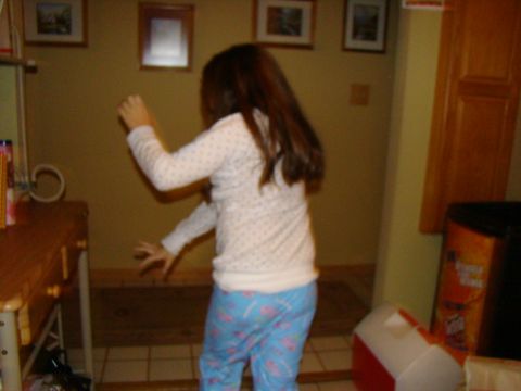 1989 Ford Bronco - A young girl dances enthusiastically in a room, her movements captured mid-motion.