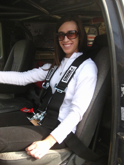 1989 Ford Bronco - Woman wearing a Crow Enterprises racing harness inside a vehicle's interior.