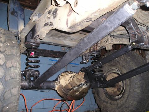 1986 Ford Bronco II - Custom suspension links and coil springs are visible on the rear axle of a vehicle.