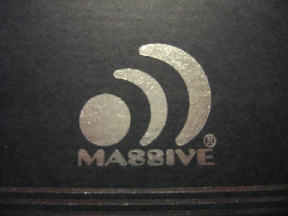 Silver 'Massive' logo with concentric arcs on a black background