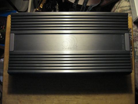 1992 Ford Crown Victoria - A car audio amplifier with the "Massive" logo is shown on a wooden surface.