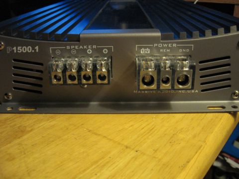 1992 Ford Crown Victoria - Rear view of a car amplifier, showing its connection terminals and branding.