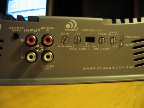 1992 Ford Crown Victoria - Close-up view of a car amplifier, showing various control knobs and input/output connections.
