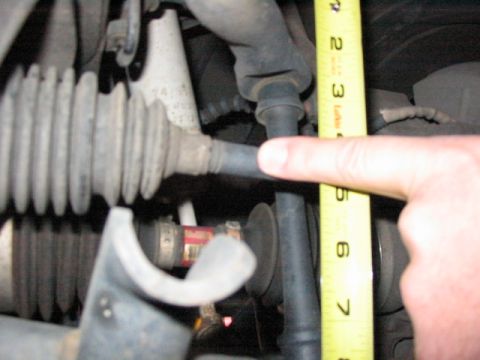 1995 Ford Bronco - Measuring suspension components with a tape measure.