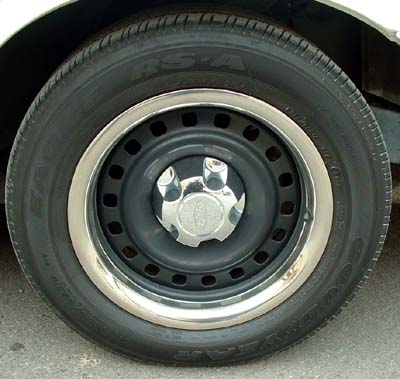 1999 Ford Crown Victoria - This photo shows a steel wheel with a chrome trim ring and a Ford center cap, not a full vehicle.