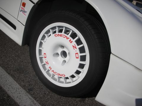1998 Ford Crown Victoria - Close-up of a white OZ Racing wheel on a white car, with red lettering visible on the wheel.