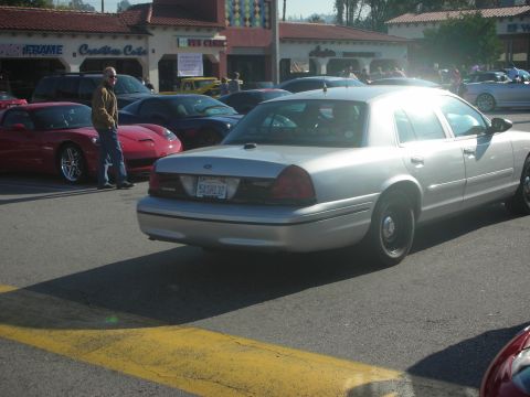 1998 Ford Crown Victoria - Silver sedan parked at a car meet, with other vehicles in the background.