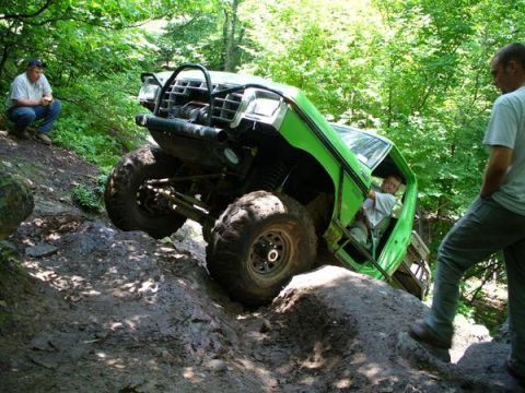1978 Ford Bronco - A modified 1978 Ford Bronco navigates a challenging off-road course, with onlookers observing its progress.