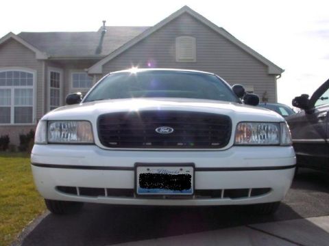 1999 Ford Crown Victoria - Front view of a 1999 Ford Crown Victoria, parked in front of a house.