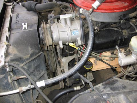 1987 Ford Bronco - Close-up view of an engine compartment, showing various mechanical components and hoses.