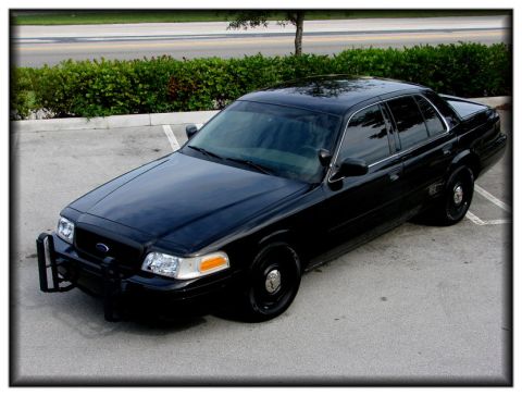 1998 Ford Crown Victoria - This 1998 Ford Crown Victoria police car is captured from a 3q-front angle, its imposing presence.