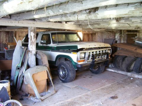 1979 Ford Bronco - This 1979 Ford Bronco is stored indoors amongst various automotive parts and tires.