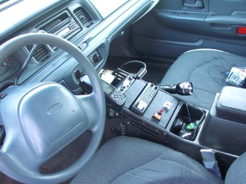 1999 Ford Crown Victoria - The interior of a 1999 Ford Crown Victoria, equipped with police radio and other accessories.