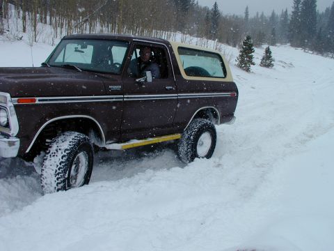 1979 Ford Bronco - Ford Bronco navigating a snowy landscape, likely off-road.