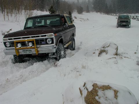 1979 Ford Bronco - A 1978 Ford Bronco navigates a snowy path with another vehicle following behind.