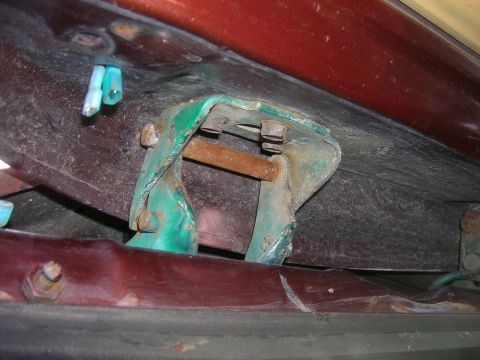 1979 Ford Bronco - Close-up of a vehicle's door hinge bracket, showing its construction and attachment points.