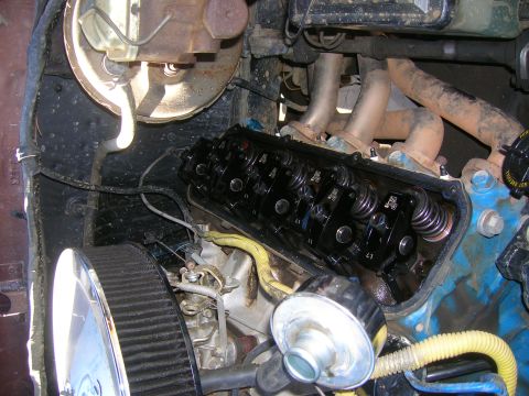 1979 Ford Bronco - The engine's internal components are exposed, revealing the rocker arms and valve springs during maintenance or repair.