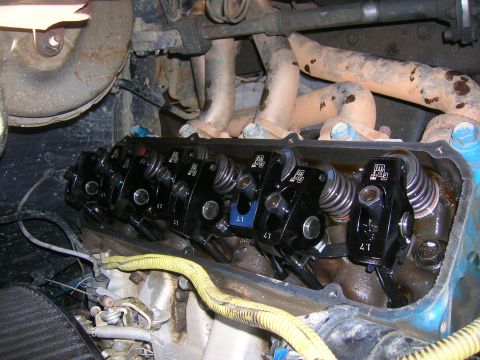 1979 Ford Bronco - Close-up view of the engine's valve train, showing black rocker arms and springs.