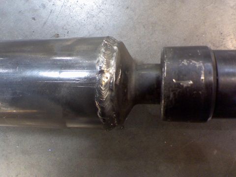 1974 Ford F-250 - Close-up of a drive shaft showing welded joints and a yoke, with a Supermotors.net watermark.