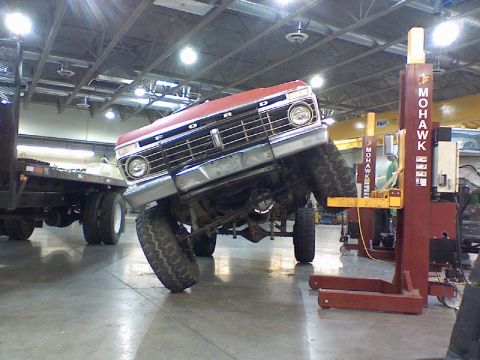 1974 Ford F-250 - Ford F-series truck on a lift, showing the front grille and tires.
