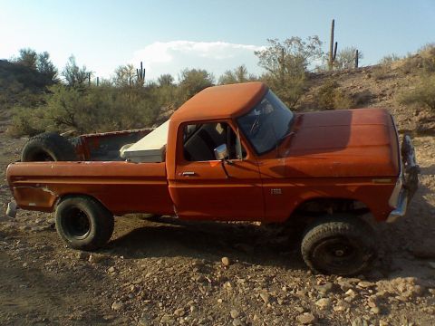 1974 Ford F-250 - This orange pickup truck appears to be from the early 1970s, possibly a 1973 model.