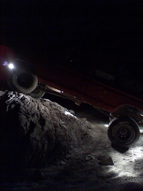 1974 Ford F-250 - Pickup truck navigating rocky terrain in the dark.