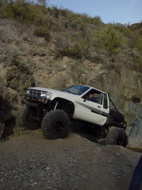 1986 Toyota Hilux - This modified 1986 Toyota Hilux navigates a steep, rocky incline, its off-road capabilities.