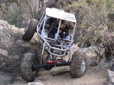 1986 Toyota Hilux - Custom off-road buggy navigates a challenging rocky incline.