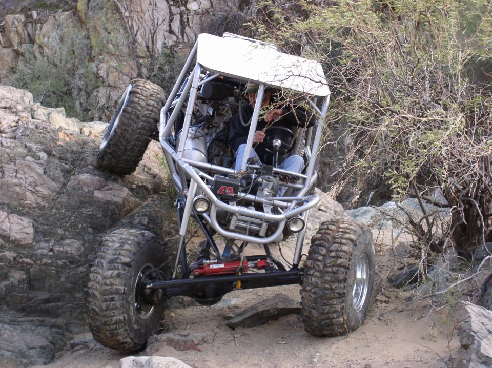 Off-road buggy climbing rocky terrain