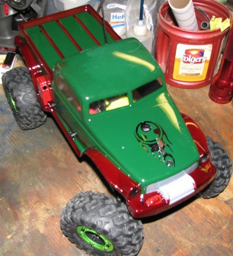 1999 Ford F-150 - Custom painted RC rock crawler truck with off-road tires and a graphic on the hood.