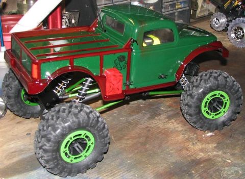 1999 Ford F-150 - This remote-controlled truck features a custom paint job with green body and red accents, including a jerry can detail.